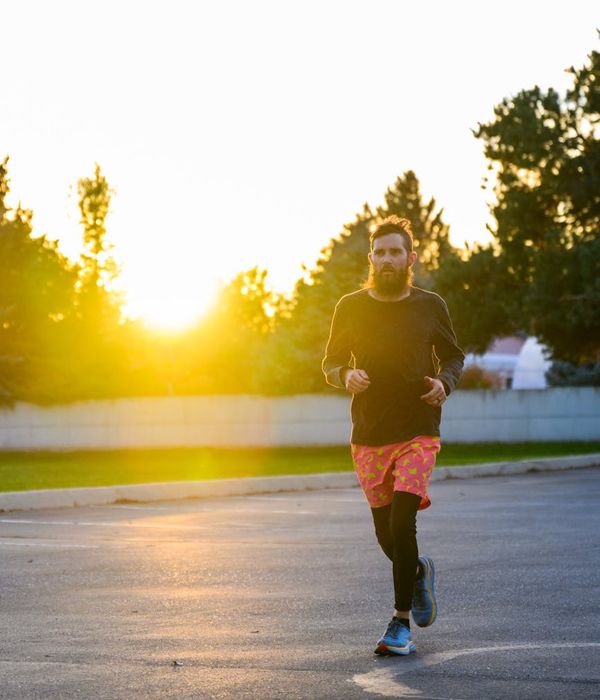 Person practicing morning breathing with serene orange glow.